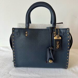 Coach Rogue 25 with Rivets